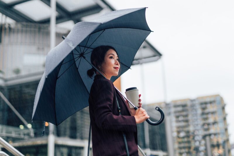 Businesswoman walking in the rain